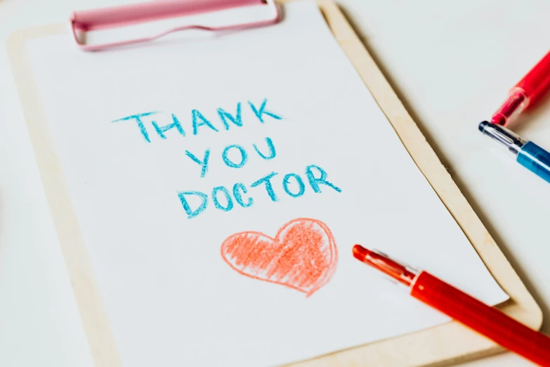 a clipboard with a thank you doctor written on it, a child's drawing, pexels contest winner, red ballpoint pen, profile image, instagram post, heart operation