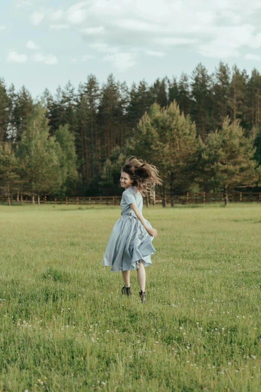 a girl in a blue dress running through a field, by Jaakko Mattila, pexels contest winner, renaissance, still from a music video, trees in the background, brave young girl, flying hair