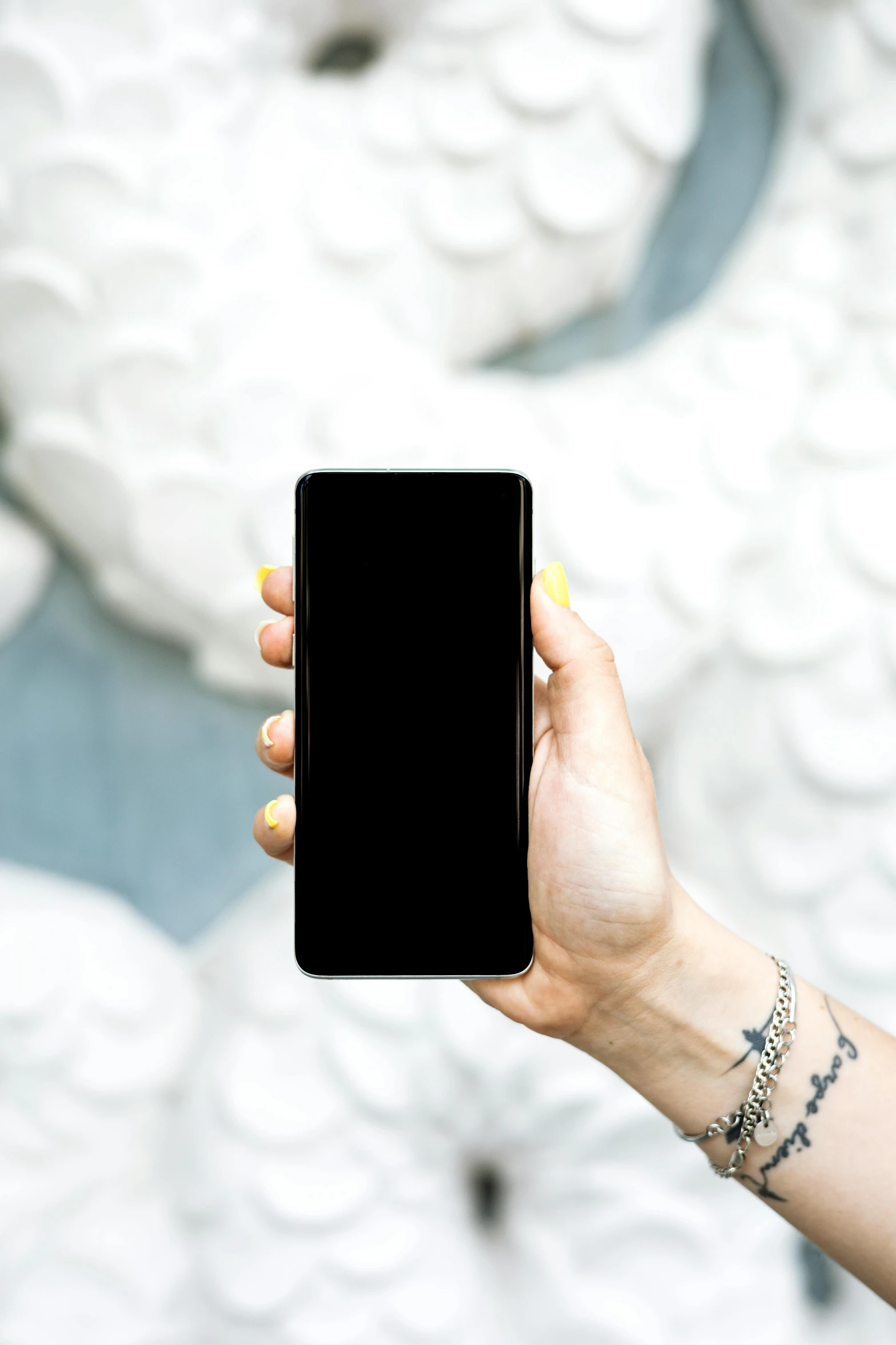 a person holding a cell phone in their hand, black main color, curated collections, detailed product image, single subject