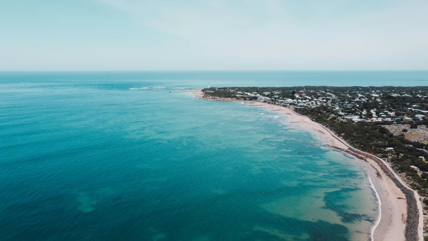 a large body of water next to a beach, by Lee Loughridge, unsplash contest winner, happening, caulfield, airborne view, coastline, plain background