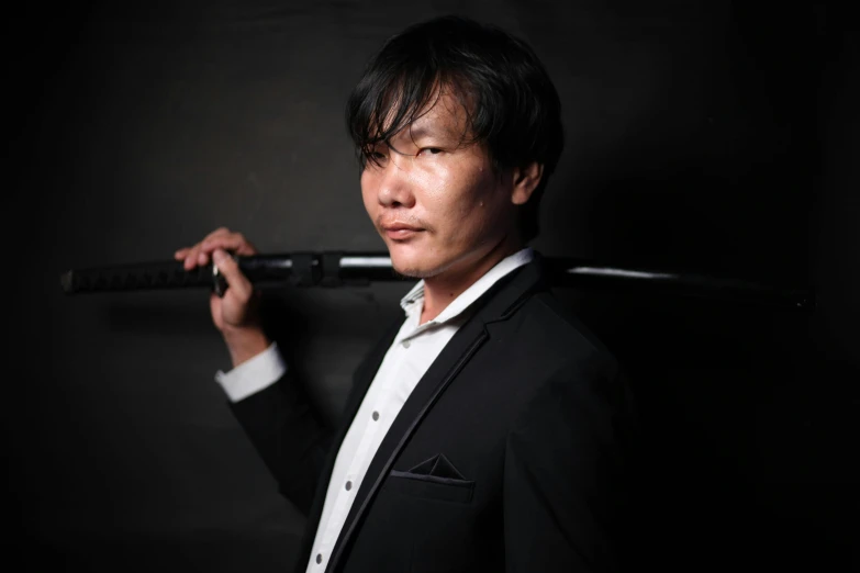 a man in a suit holding a baseball bat, an album cover, inspired by Hiroyuki Tajima, unsplash, shin hanga, headshot profile picture, hideo kojima, medium shot portrait, heise-lian yan fang