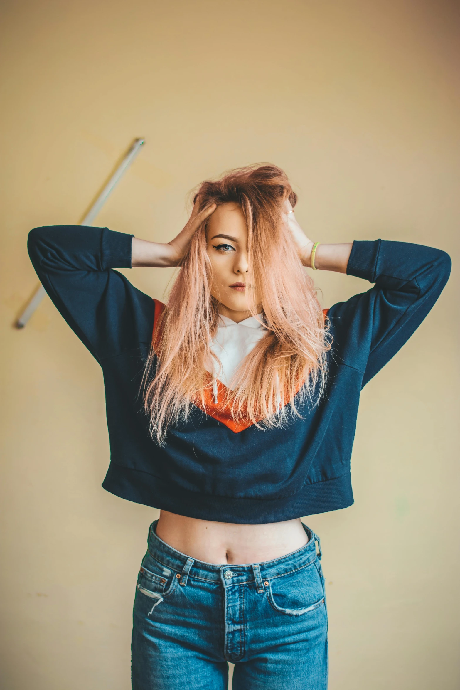 a woman with pink hair holding a baseball bat, inspired by Elsa Bleda, trending on pexels, renaissance, wearing sweatshirt, exposed midriff, 90's color photo, maisie williams