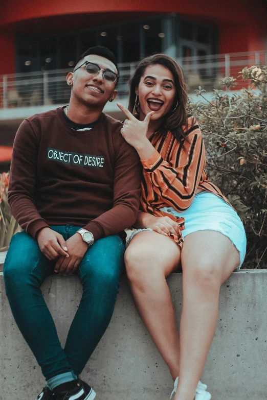 a man and a woman sitting next to each other, a picture, pexels contest winner, casual streetwear, excited, lesbians, promo image