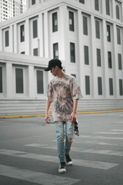 a man walking across a street holding a skateboard, inspired by Gang Hui-an, unsplash, lyco art, wearing a tie-dye t-shirt, baggy jeans, view(full body + zoomed out), he is about 20 years old | short