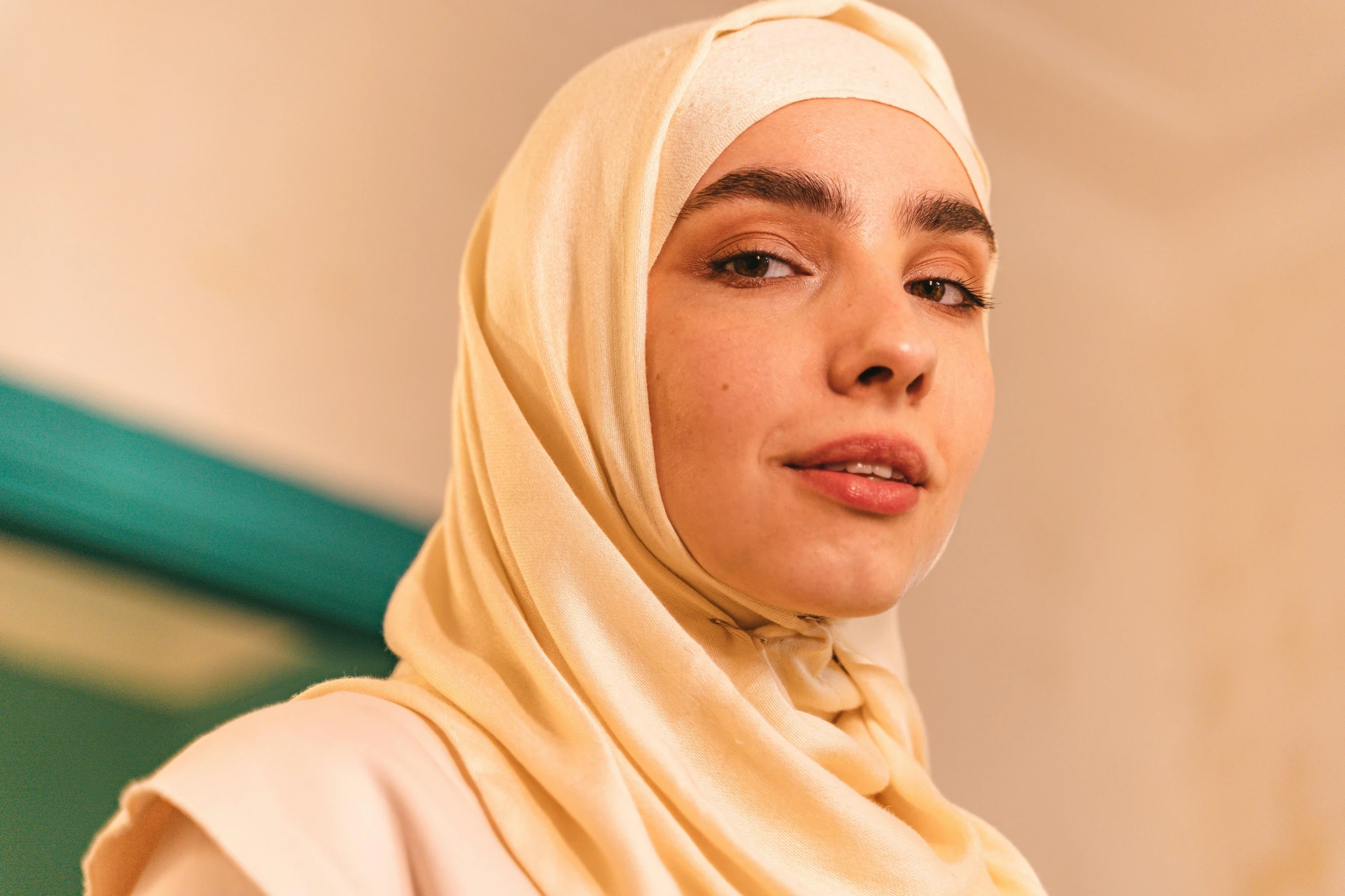 a close up of a person wearing a headscarf, trending on pexels, hurufiyya, slight yellow hue, dua lipa, full body image, a handsome