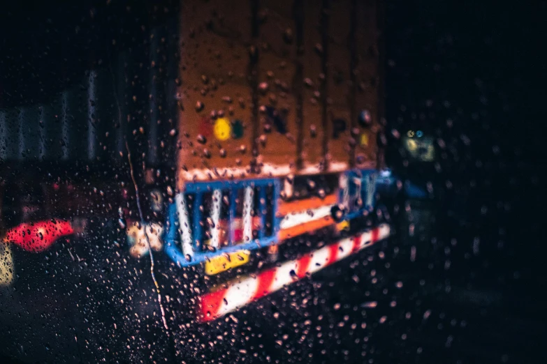 a view of a train through a rain covered window, inspired by Elsa Bleda, unsplash contest winner, photorealism, a firetruck at night, neon reflections, wet reflections in square eyes, unsplash 4k