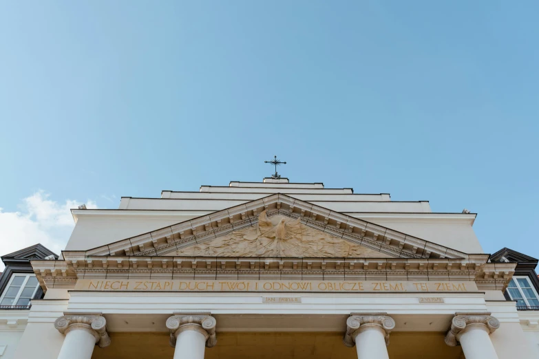 a large white building with columns and a cross on top, by Julia Pishtar, unsplash, neoclassicism, bottom view, orthodox, front face, high forehead