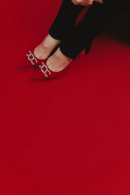 a woman sitting on top of a red floor, stilettos, in thomas ruff style, inauguration, uncrop