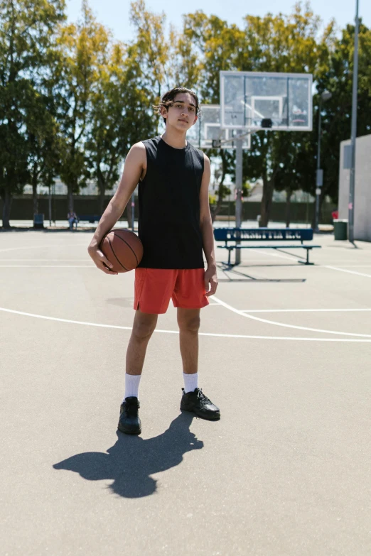 a young man standing on a basketball court holding a basketball, by Gavin Hamilton, dribble contest winner, tight black tank top and shorts, madison beer, profile image, wearing red converse shoes