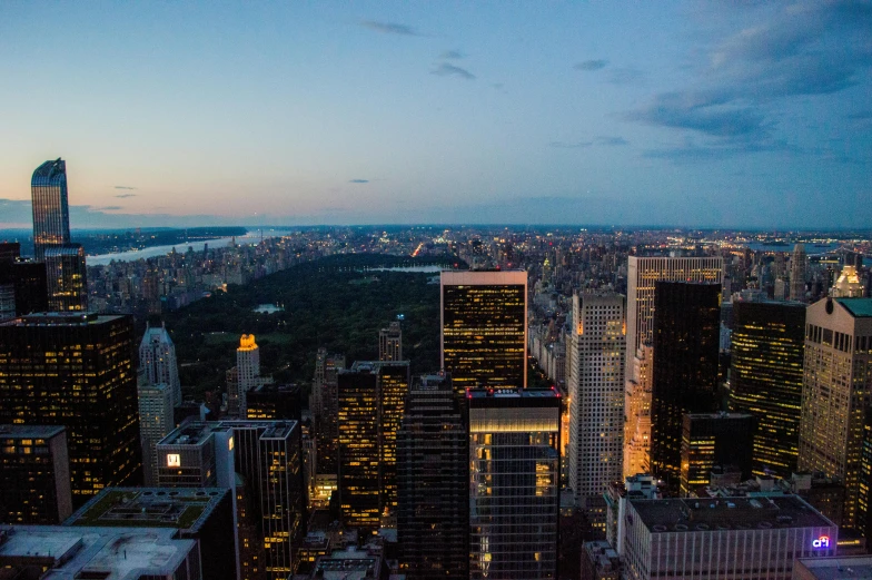 a view of a city from the top of a building, by Daniel Lieske, pexels contest winner, central park, summer evening, slide show, 4k resolution”