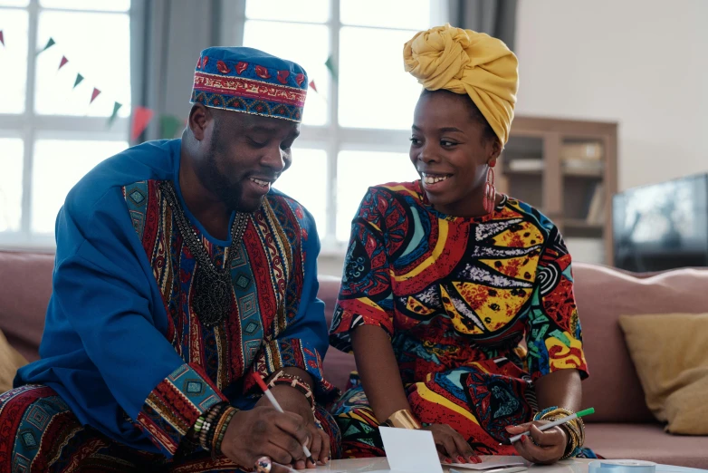 a man and a woman sitting on a couch, by Chinwe Chukwuogo-Roy, pexels contest winner, afrofuturism, signing a bill, wearing an african dress, happy couple, official screenshot