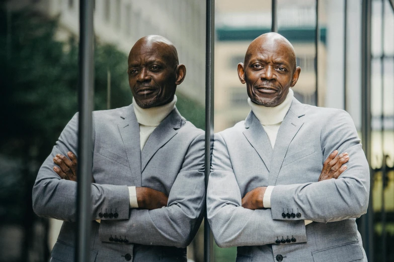 a couple of men standing next to each other, inspired by George Bain, pexels contest winner, lance reddick, 5 0 years old man, mirroring, fully dressed