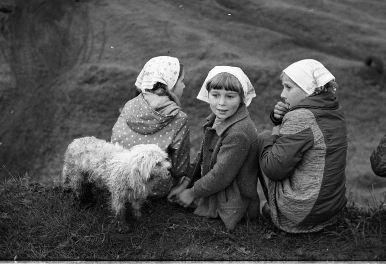 a black and white photo of three children and a dog, a black and white photo, by Maurycy Gottlieb, naive art, ukraine. photography, girls resting, on a green hill, hans dahl