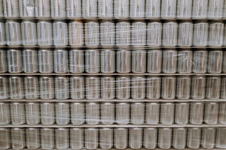 a stack of cans stacked on top of each other, unsplash, inspect in inventory image, 1 6 x 1 6, plastic wrap, gleaming silver