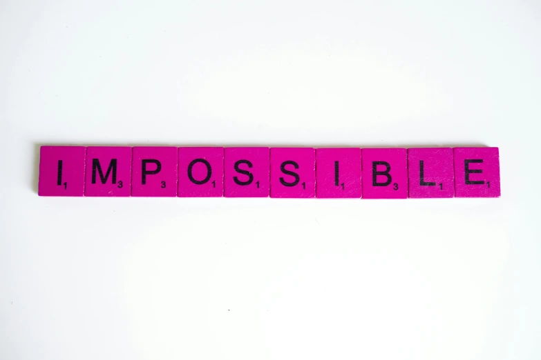 a pink wooden block with the word impossible on it, by Joseph-Marie Vien, unsplash, barbara kruger, with a white background, mission impossible, 3 4 5 3 1