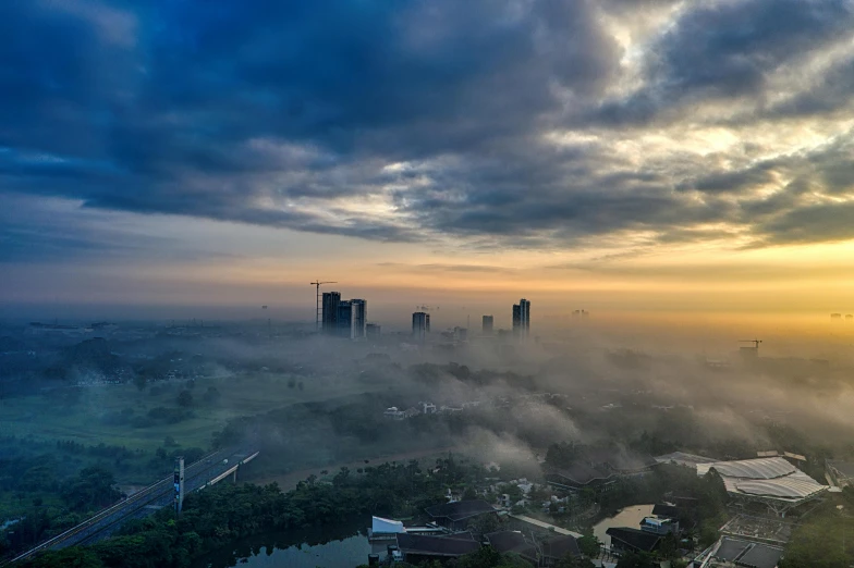 a view of a city on a foggy day, by Erik Pevernagie, unsplash contest winner, hurufiyya, sri lankan landscape, sunset in the clouds, university, partly cloudy day