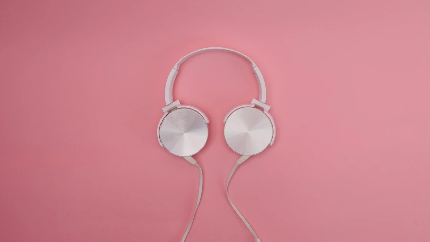 a pair of headphones on a pink background, by Andries Stock, trending on pexels, silver，ivory, very simple, jacqueline e