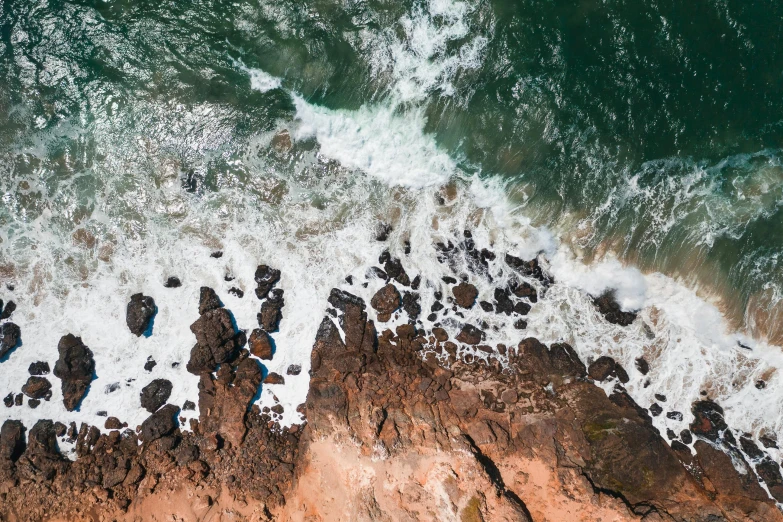 a view of the ocean from a bird's eye view, pexels contest winner, waves crashing at rocks, “ iron bark, red sand, 4k footage