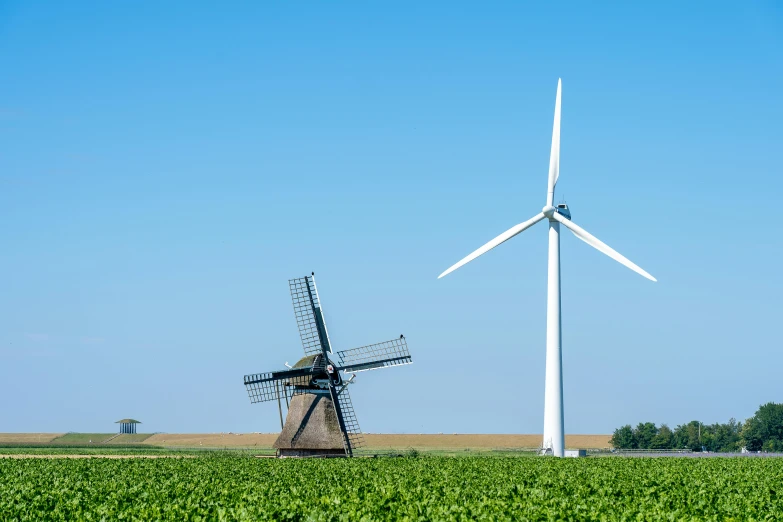 two windmills standing next to each other in a field, by Schelte a Bolswert, pexels contest winner, vincent callebaut, blue sky, museum quality photo, large format picture