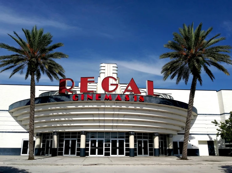 a large white building with palm trees in front of it, regal clothing, movies, thumbnail, florida