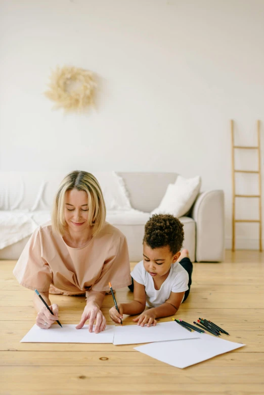 a woman and a child are sitting on the floor, a child's drawing, pexels contest winner, sitting on a mocha-colored table, gif, a blond, natural light in room