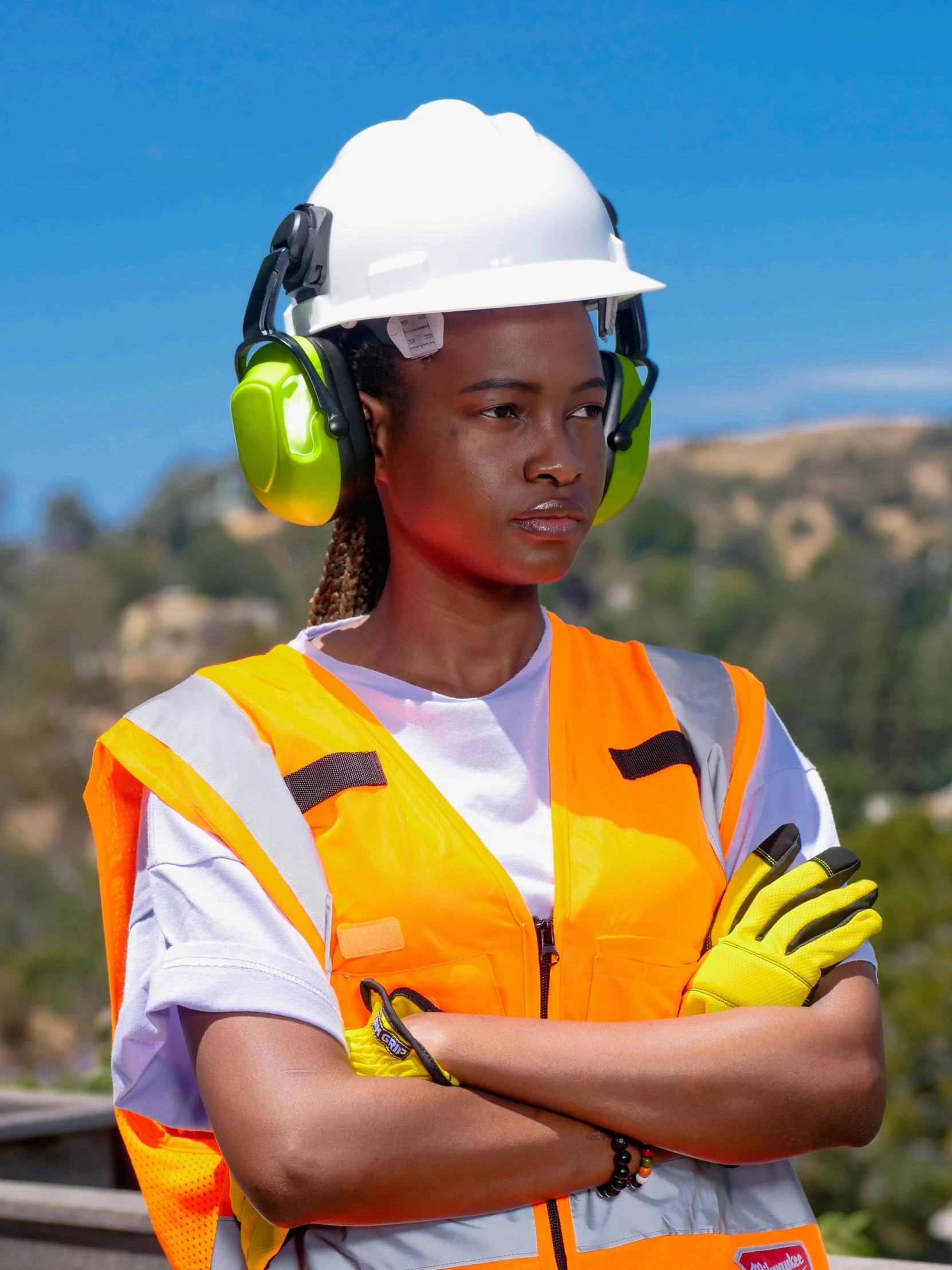 a woman in a hard hat and safety vest, inspired by Afewerk Tekle, 2019 trending photo, wearing headset, ladies, wearing gloves