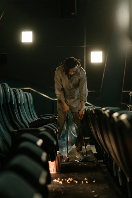 a man cleaning the seats of a movie theater, a portrait, unsplash contest winner, adam driver behind, [ theatrical ]