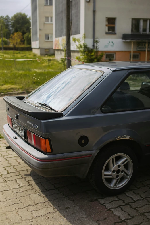 a car parked on the side of the road, ae 8 6, spoiler, highly reflective surface, mustang