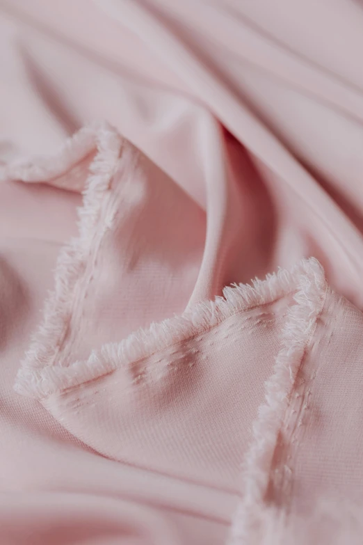 a close up of a pink cloth with fray edges, soft blush, pink waterfalls, product shot, opening shot