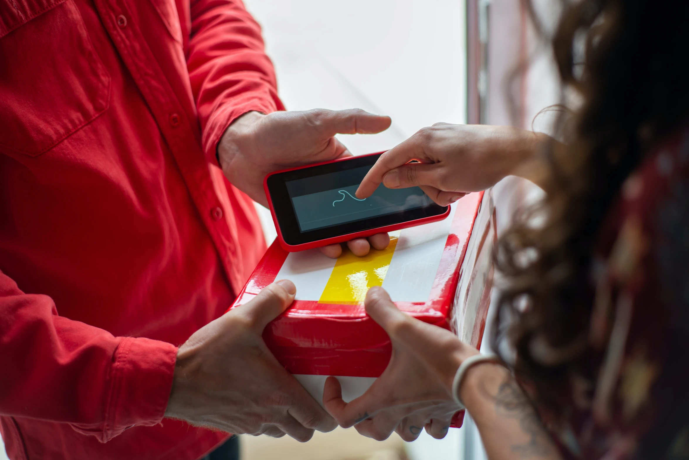 a close up of a person holding a cell phone, giving gifts to people, at checkout, red and yellow scheme, digital pong screen