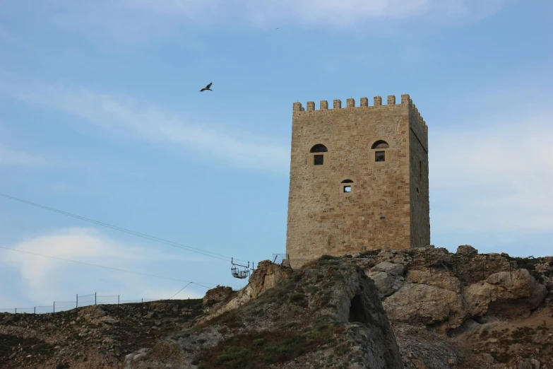 a tall tower sitting on top of a rocky hill, by Altichiero, pexels contest winner, les nabis, jerez, square, bird sight, high quality picture