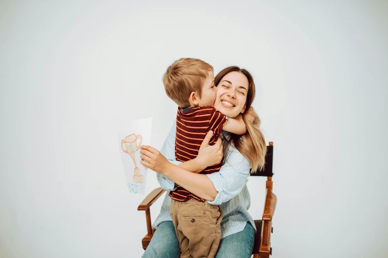 a woman sitting in a chair holding a child, a child's drawing, pexels contest winner, hugging each other, profile image, cute boy, high resolution photo