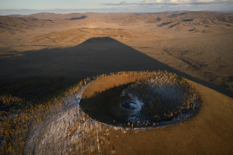 a large crater in the middle of a desert, unsplash contest winner, land art, ai weiwei and gregory crewdson, russia, “ golden chalice, wide high angle view