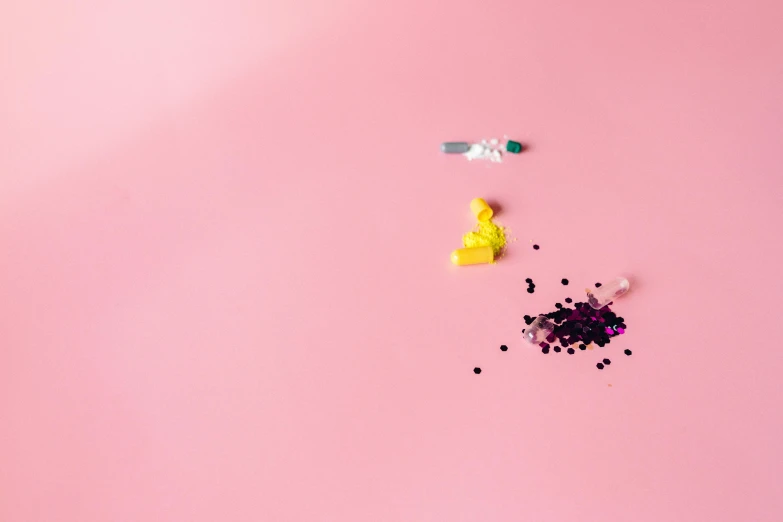 sprinkles and confetti on a pink background, a picture, by Julia Pishtar, plasticien, syringe, broken toys, surgeon, background image