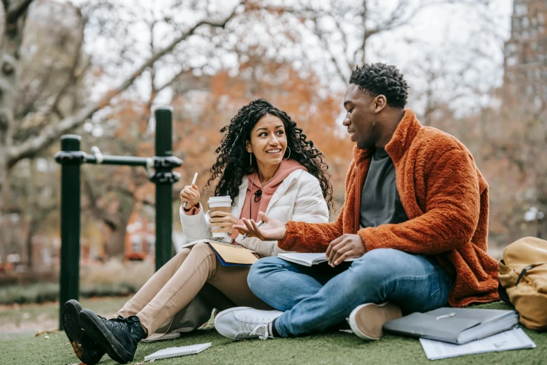 a man and a woman sitting on the grass, trending on pexels, academic art, diverse, sitting on a mocha-colored table, sydney park, background image