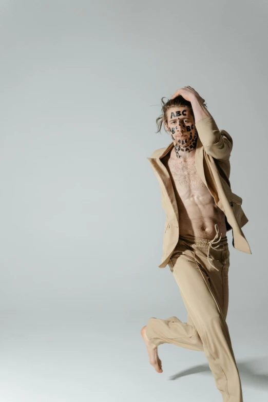 a man in a suit jumping in the air, an album cover, inspired by derek zabrocki, neo-figurative, emaciated, wearing loincloth, 2019 trending photo, muted browns