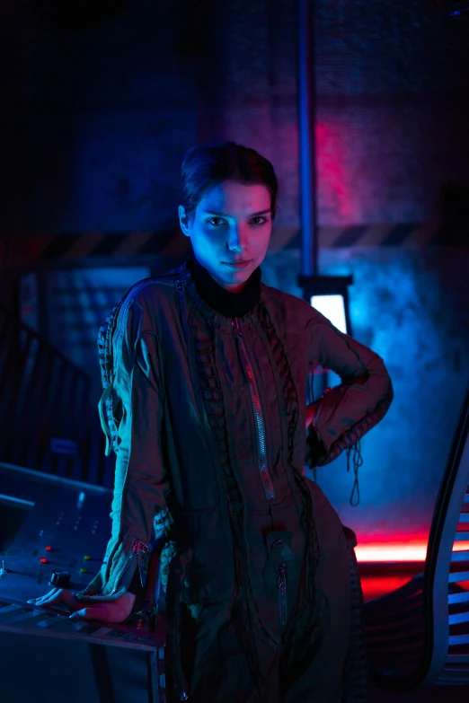 a woman standing in front of a computer in a dark room, cyberpunk art, trending on cgsociety, bauhaus, dressed anya taylor - joy, movie still of the alien girl, model is wearing techtical vest, promotional image
