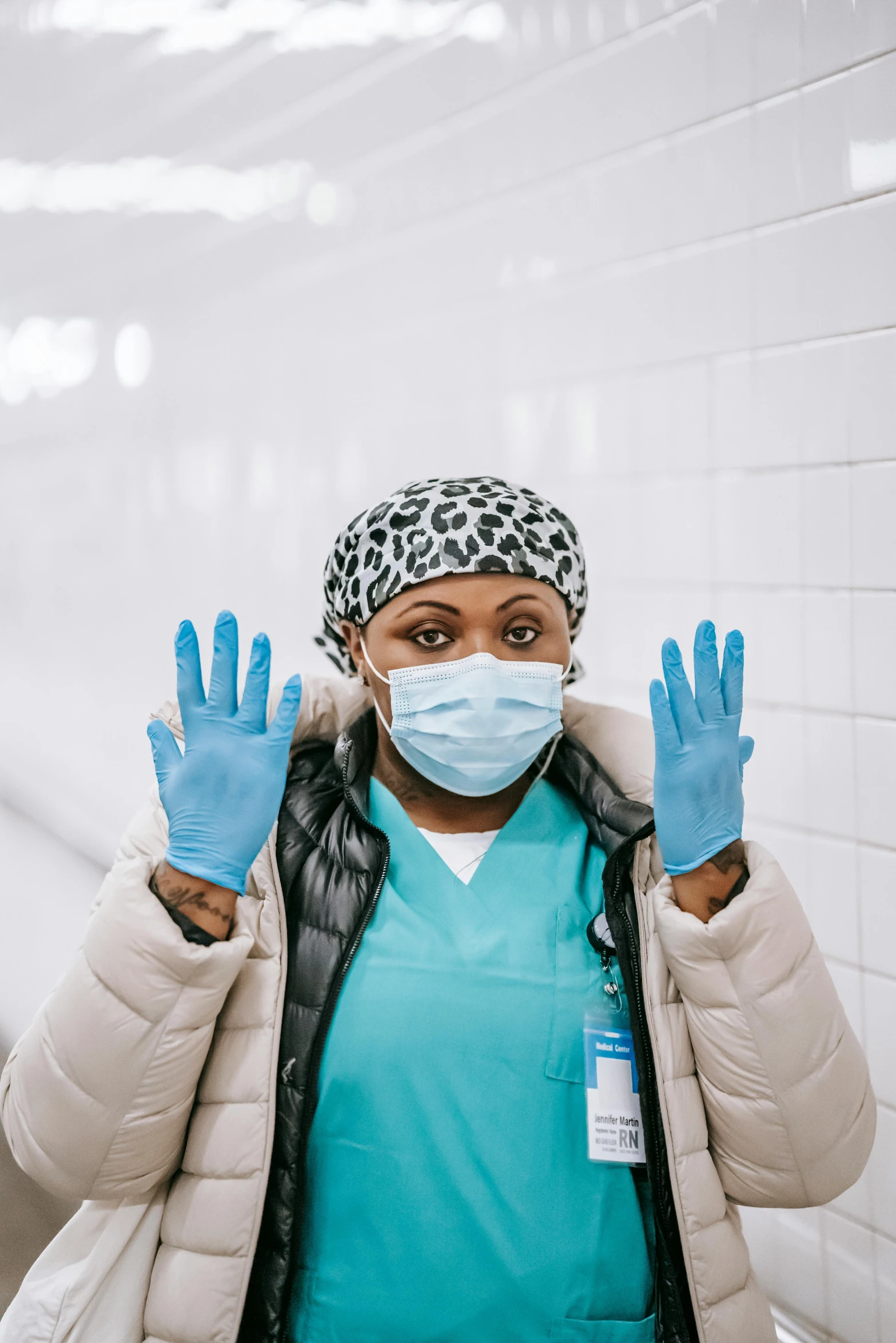 a woman wearing a surgical mask and gloves, by Arabella Rankin, pexels contest winner, african woman, nyc, instagram picture, hospital background