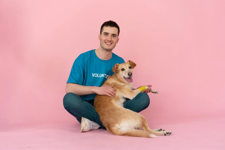 a man in a blue shirt is holding a dog, pink, heavily upvoted, on simple background, holding a staff