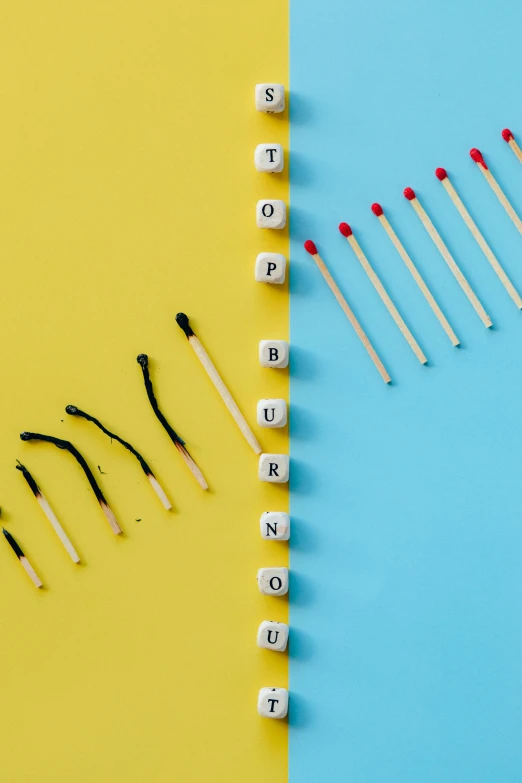 a row of matches next to a row of matches on a blue and yellow background, by Julia Pishtar, auto-destructive art, smokey burnt love letters, getty images, toys, sunburn