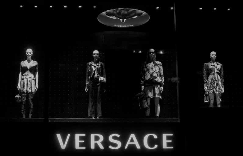 a black and white photo of several mannequins in a store window, by Sebastian Vrancx, unsplash contest winner, renaissance, 80s versace ad, on black background, two still figures facing camera, wearing versace sunglasses