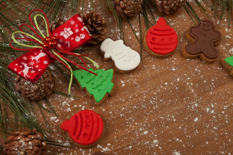 a bunch of cookies sitting on top of a table, inspired by Ernest William Christmas, pexels, folk art, evergreen branches, red and brown color scheme, rectangle, multi - coloured