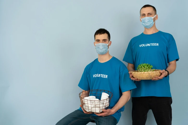 two men wearing face masks holding baskets of food, a portrait, pexels contest winner, wearing shirts, avatar image, cyan photographic backdrop, clean medical environment