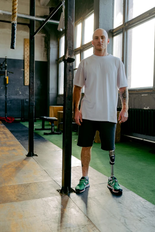 a man with a prosthetic leg standing in a gym, a portrait, unsplash, full body hero, uploaded, hyperdetailed!, michal