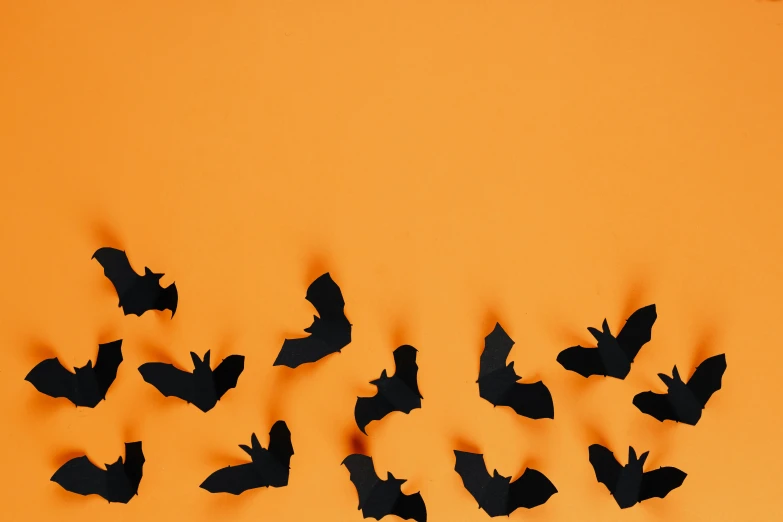 a flock of bats flying in the sky, trending on pexels, conceptual art, orange metal ears, paper cutout, on a canva, thumbnail