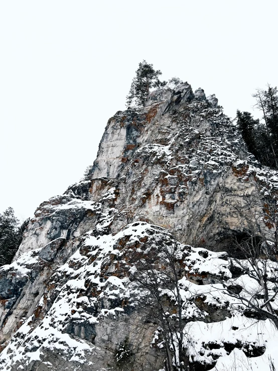 a man riding a snowboard down a snow covered slope, an album cover, unsplash, les nabis, extremely detailed rocky crag, slightly pixelated, spire, limestone