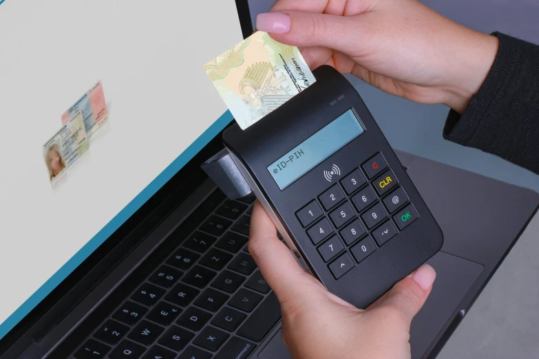 a person holding a calculator in front of a laptop, private press, at checkout, cairo, digital lines, very detailed »