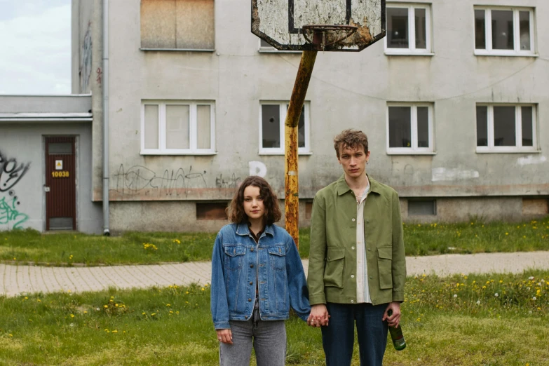 a man and a woman standing in front of a basketball hoop, an album cover, by Attila Meszlenyi, pexels contest winner, bauhaus, wearing a jeans jackets, post - soviet courtyard, 15081959 21121991 01012000 4k, young and slender