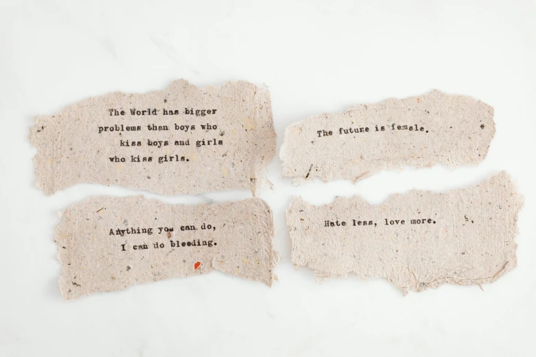 two pieces of paper with words written on them, inspired by Dorothy Burroughes, unsplash, feminist art, made of cement, seeds, cute boys, packaging of the world