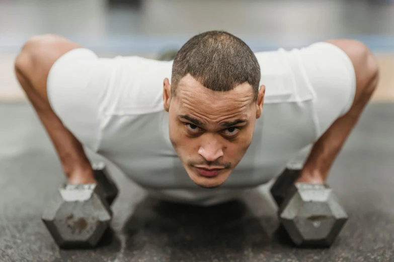 a man is doing push ups with dumbbells, pexels contest winner, looking to the side off camera, damien tran, square masculine jaw, avatar image